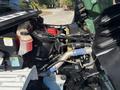 Close-up view of the engine compartment of a 2019 Freightliner M2 106 featuring various components including a black air filter red coolant reservoir and metal piping