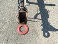 Close-up of a rusty hitch coupling with a red safety ring on a 2010 Vermeer Corporation BC1200XL