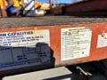 A 2010 Skyjack SJ lift with red metal platform and faded labels detailing operational capacities and checklist for safe use