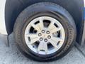 A silver wheel with a five-spoke design mounted on a black tire marked with the brand name BFGoodrich and the model Advantage T/A