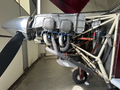 A 1986 Sorrell Hiperbipe SNS-7 amateur-built aircraft showcasing its engine with visible Avco Lycoming branding and intricate plumbing and wiring details