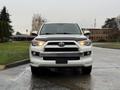 A 2018 Toyota 4Runner facing forward with a white exterior and a prominent front grille featuring the Toyota emblem