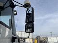Close-up of the side mirror of a 2013 International WorkStar truck with a chrome and black design showcasing its elongated shape and glass surface