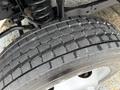 Close-up of a tire on a 2012 Ford F-450 SD showcasing tread patterns and texture indicating wear and use