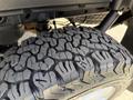 Close-up of a rugged tire from a 2018 Ford F-150 featuring aggressive tread patterns designed for enhanced traction and off-road performance