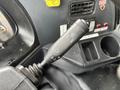 Close-up of a control lever in a 2017 Autocar Xpert with settings for wipers and headlights displayed on the knob