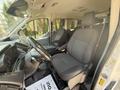 Interior view of a 2017 Ford Transit with two front seats featuring fabric upholstery and a steering wheel in the foreground