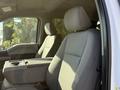 Interior of a 2021 Ford F-250 SD featuring gray fabric bucket seats and a center console