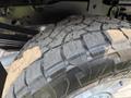 Close-up of a rugged tire from a 2020 Ford F-350 SD showcasing deep treads and textured rubber surface
