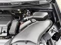 A close-up view of the engine compartment of a 2014 Honda Odyssey showing the air intake system and other engine components