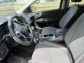 Interior of a 2015 Ford Escape showing front seats and dashboard with steering wheel and gear shift