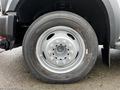 Close-up of a 2009 Ford F-550 front tire and steel rim showing a five-bolt pattern and Michelin branding