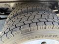Close-up of a 2016 Isuzu NRR tire showing a detailed tread pattern and sidewall markings with size specifications 225/70R19