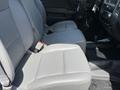 Front seats of a 2016 Chevrolet Silverado 2500HD featuring gray upholstery and seat belts visible