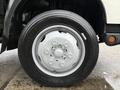 Close-up of a silver wheel from a 2015 Hino 195 featuring a multi-spoke design and a black tire with visible tread pattern