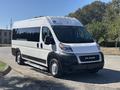 A white 2020 RAM ProMaster 3500 van with a streamlined design and black grille parked on a road