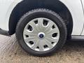 A close-up view of a wheel from a 2019 Ford Transit Connect featuring a silver hubcap and a black tire with treads