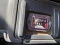 A close-up of a Hobbs quartz hour meter displaying 0900 hours in a vintage GMC Top Kick vehicle