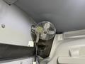 A small silver fan mounted on the interior wall of a 2023 Ford Transit van