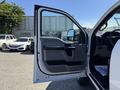 2017 Ford F-350 SD with an open driver's door showing the interior design and controls of the truck