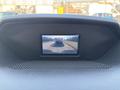 Display screen showing a rearview camera feed from a 2016 Ford Transit 150 with guiding lines for parking assistance