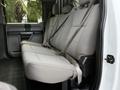 Interior view of a 2017 Ford F-450 Super Duty showing the rear bench seat with seatbelts and a textured fabric pattern