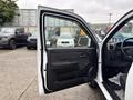 A 2011 Chevrolet Colorado with the driver's side door open showing the interior and dashboard details
