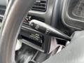 A close-up view of the windshield wiper control lever inside a 2008 Suzuki Carry showing markings for different wiper settings