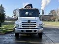 Front view of a white 2015 Hino 358 truck with chrome grille and headlights visible
