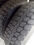 A close-up of a heavy-duty tire from a 2011 Ford F-750 showing a detailed tread pattern with visible wear and cracks
