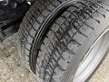 Close-up of the tread on two tires of a 2016 Ford F-550 Super Duty showcasing deep grooves and a rugged, durable design