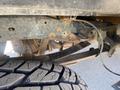 A 2016 Ford F-350 SD truck chassis with visible suspension components and a close-up view of a rugged tire tread