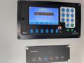 A control panel featuring a screen displaying "NOT IN SERVICE" along with a numeric keypad and various buttons for menu navigation and route options