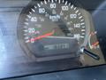 The image shows the dashboard of a 2016 Isuzu NPR-HD with a speedometer displaying 0 to 140 km/h and an odometer reading 165841