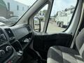 Interior of a 2017 RAM Promaster showing the driver's seat dashboard and side mirror with controls and storage compartments visible