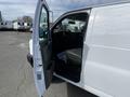 2022 GMC Savana with the driver's door open showing the interior dashboard and seat