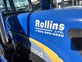 A blue 2010 New Holland T4050 tractor with a prominent logo of Rollins Machinery Ltd on the side