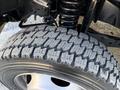 Close-up of a 2009 Ford F-550 tire showcasing its detailed tread pattern and sturdy rim designed for heavy-duty performance