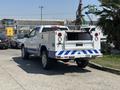 A white 2017 Chevrolet Colorado truck with a utility bed featuring blue and white graphics on the sides