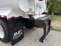 A 2025 Peterbilt 536 truck featuring a sleek white design with a large tank at the rear and black mud flaps displaying the AMG logo
