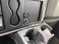 Interior dashboard of a 2014 International Durastar showing two USB ports a lighter socket and a cup holder