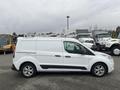 A white 2017 Ford Transit Connect van parked with a roof rack and side sliding door visible