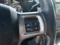 Close-up of a steering wheel control panel featuring buttons labeled On/Off, Resume, Cancel, and Set in a 2018 RAM 3500