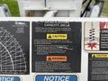 A close-up view of a warning label on a 2013 Freightliner 114SD detailing safety capacities and operating instructions for platform use