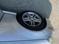 A silver 2013 Mercedes-Benz C-Class car with a distinctive rim and tire in the foreground