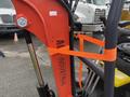 A close-up of a 2025 AGT Industrial machine featuring an orange securing strap around a metal arm with the label AGT INDUSTRIAL visible