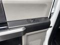 Door control panel of a 2017 Ford F-150 featuring buttons for window operations and textured surfaces