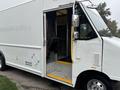 2012 Ford E-450 Super Duty with an open door showing the interior and steps leading inside