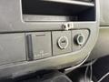 Close-up of the dashboard controls in a 2017 Chevrolet Express featuring a power outlet a USB port and a small compartment