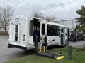 A 2013 Chevrolet Express with a wheelchair lift lowered and the rear door open